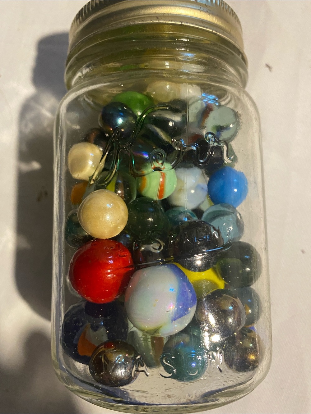 Vintage Kerr glass mason jar filled with assorted  glass vintage marbles